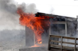 Flames Rising Out from One of the Out Buildings