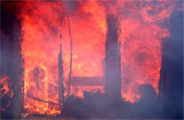 Flames Rising Out from One of the Out Buildings