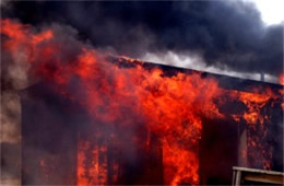 Flames Rising Out from One of the Out Buildings