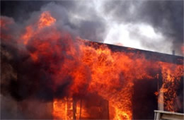 Flames Rising Out from One of the Out Buildings