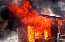 Flames Rising Out from One of the Out Buildings