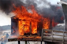 Flames Rising Out from One of the Out Buildings