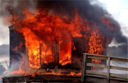 Flames Rising Out from One of the Out Buildings