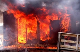 Flames Rising Out from One of the Out Buildings