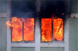 Structure Filled with Fire Inside Seen Through Windows