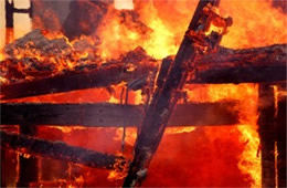 Fallen House Beams Engulfed in Flame