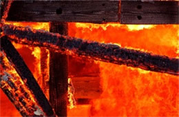 Fallen House Beams Engulfed in Flame