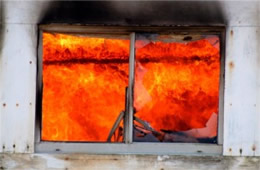 Structure Filled with Fire Inside Seen Through Window