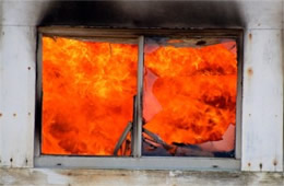 Structure Filled with Fire Inside Seen Through Window