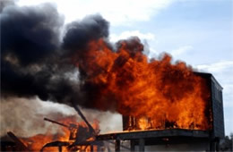 Flames Rising Out from One of the Out Buildings